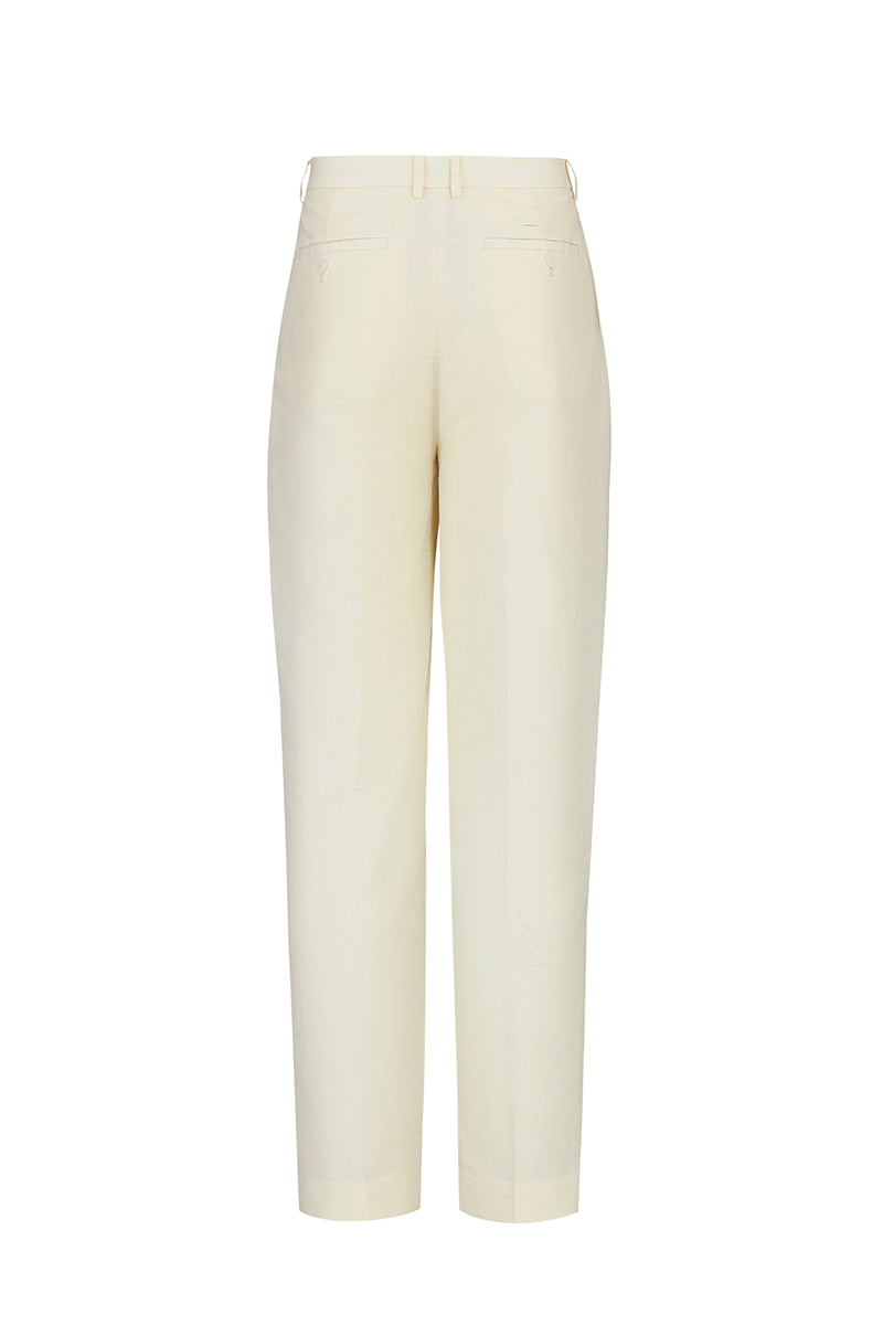 Beige cotton linen pants by Chictopia, showing relaxed fit and lightweight fabric on a neutral background.