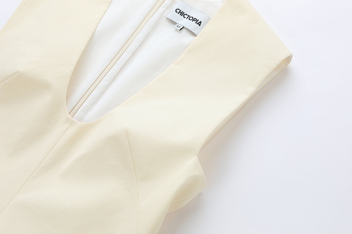 Cream cotton mini dress by Chictopia, shown on model with short sleeves and relaxed fit, perfect for casual summer wear.