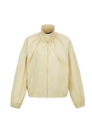 Beige cotton bomber jacket by Chictopia, featuring a classic fit with ribbed cuffs and collar, displayed on a hanger.