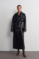 Black leather trench jacket by Acaria Studio, featuring classic design and sleek fit, displayed on a hanger against a neutral background.