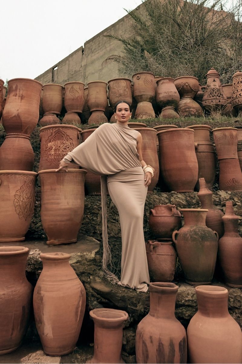 Khanum's taupe maxi dress with flowing fabric, long sleeves, and elegant design perfect for stylish occasions.