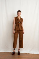Brown Acaria Studio Terra vest displayed on a model, featuring a stylish, sleeveless design with a textured fabric.