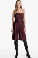 Acaria Studio Guru Shorts in deep red wine color, casual shorts with a comfortable fit, shown on a hanger.