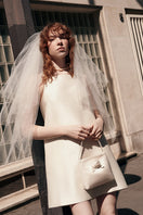 Ivory square neck mini dress by Chictopia, shown on a model with short sleeves, fitted waist, and above-the-knee length.
