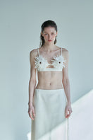 JINSUN ivory tweed applique bra top with structured design and decorative details, shown on a plain background.