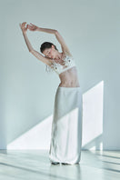 JINSUN PAPPUS Tweed Maxi Skirt in ivory, flowing design with textured fabric, displayed on a neutral background.