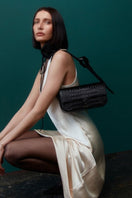 Black croco leather Katrine shoulder bag by Vikele Studio, showcasing its textured crocodile pattern and elegant design.
