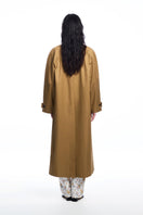 Long brown trench coat with a collar from Chictopia, shown hanging on a wooden hanger with a classic design.