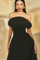 L'SCARLETT off-shoulder poly crepe flared gown displayed on hanger, showcasing elegant neckline and flowing skirt.