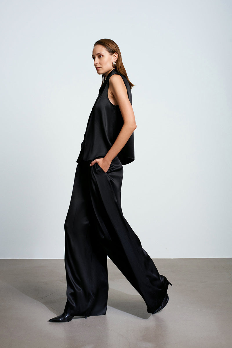 Black satin top by Acaria Studio featuring a sleek, smooth fabric and stylish design.