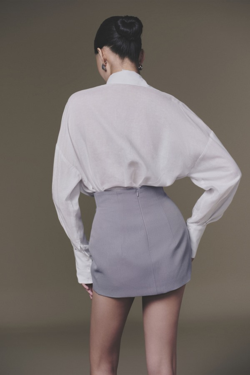 Grey Lily mini skirt by Keira Tong, featuring a fitted high-waist design and stylish mini length, shown on a model.