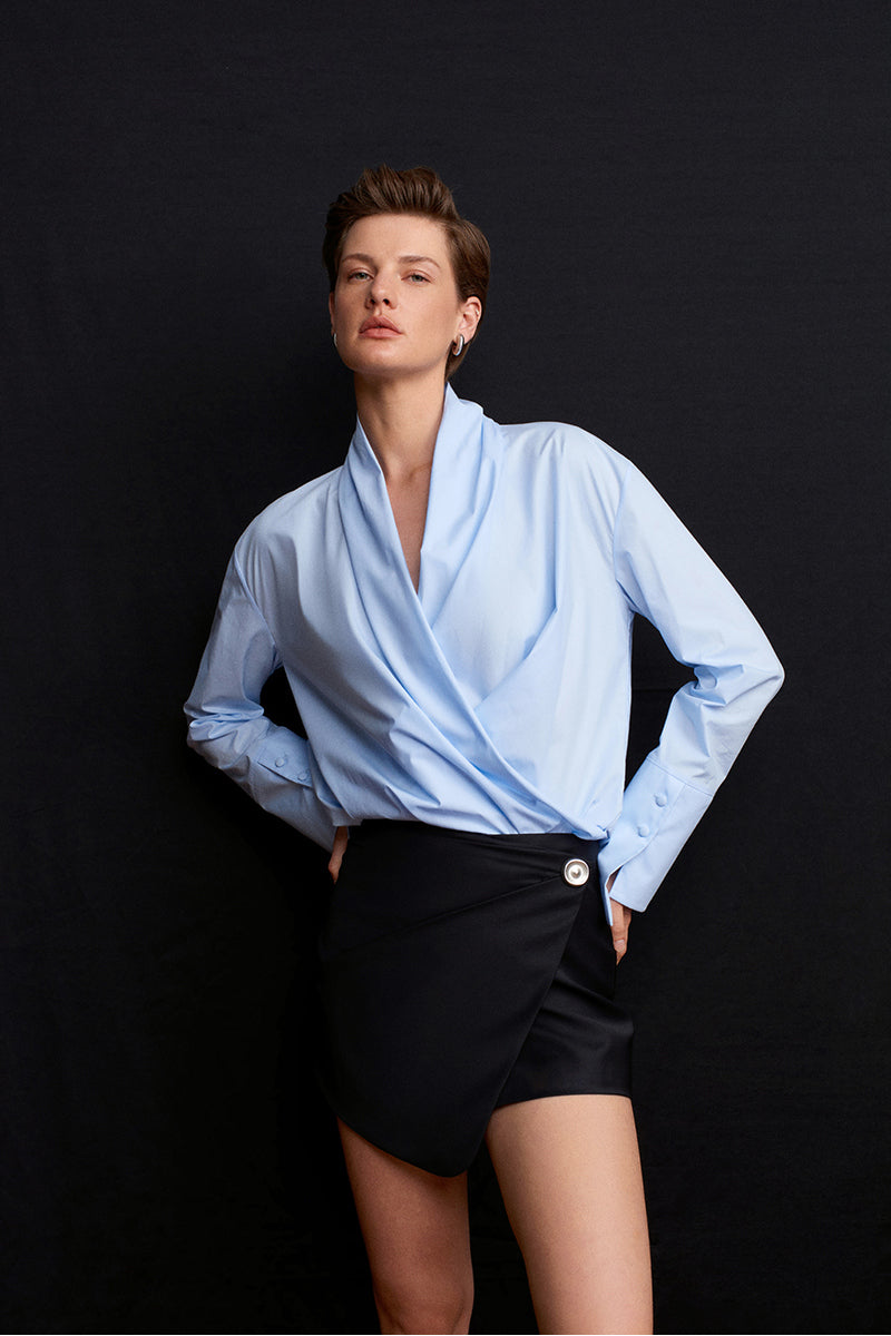 Blue historical shirt by Acaria Studio with detailed fabric and classic design, shown on a mannequin.