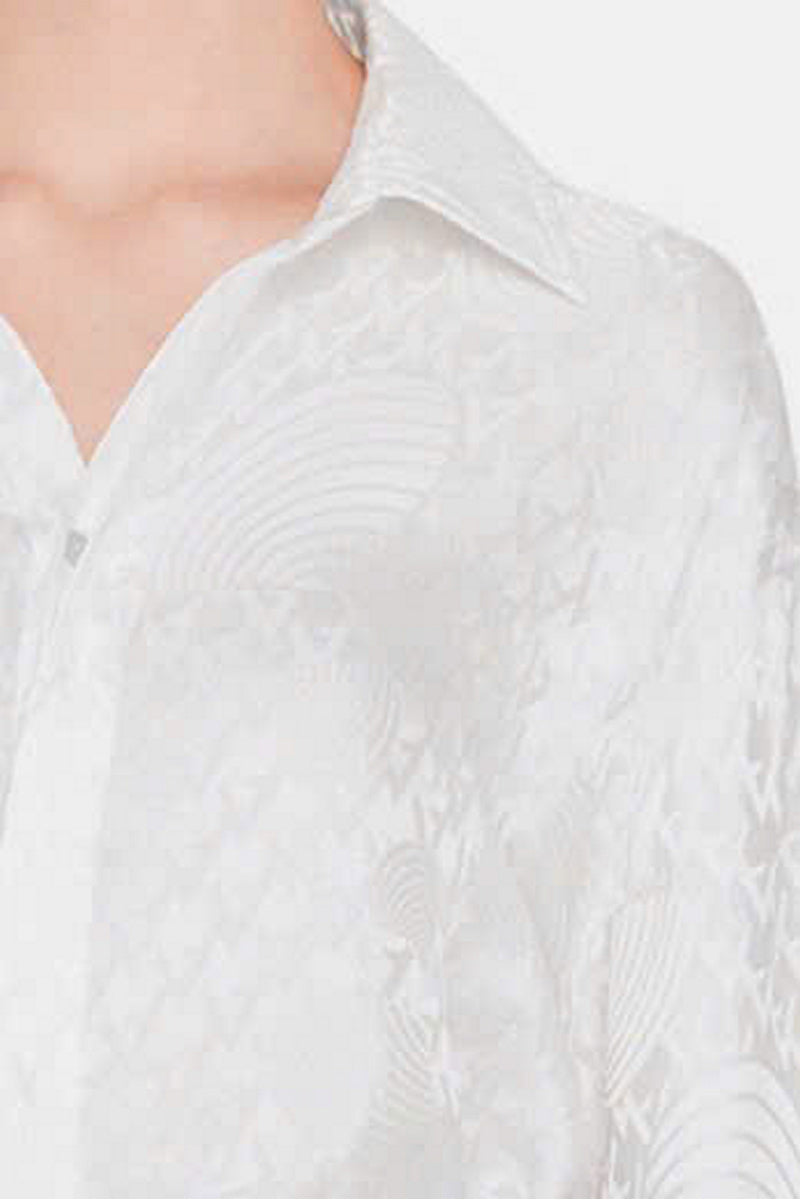 White silk shirt from Valenciani, showcasing a smooth fabric and classic collar on a neatly tailored shirt.
