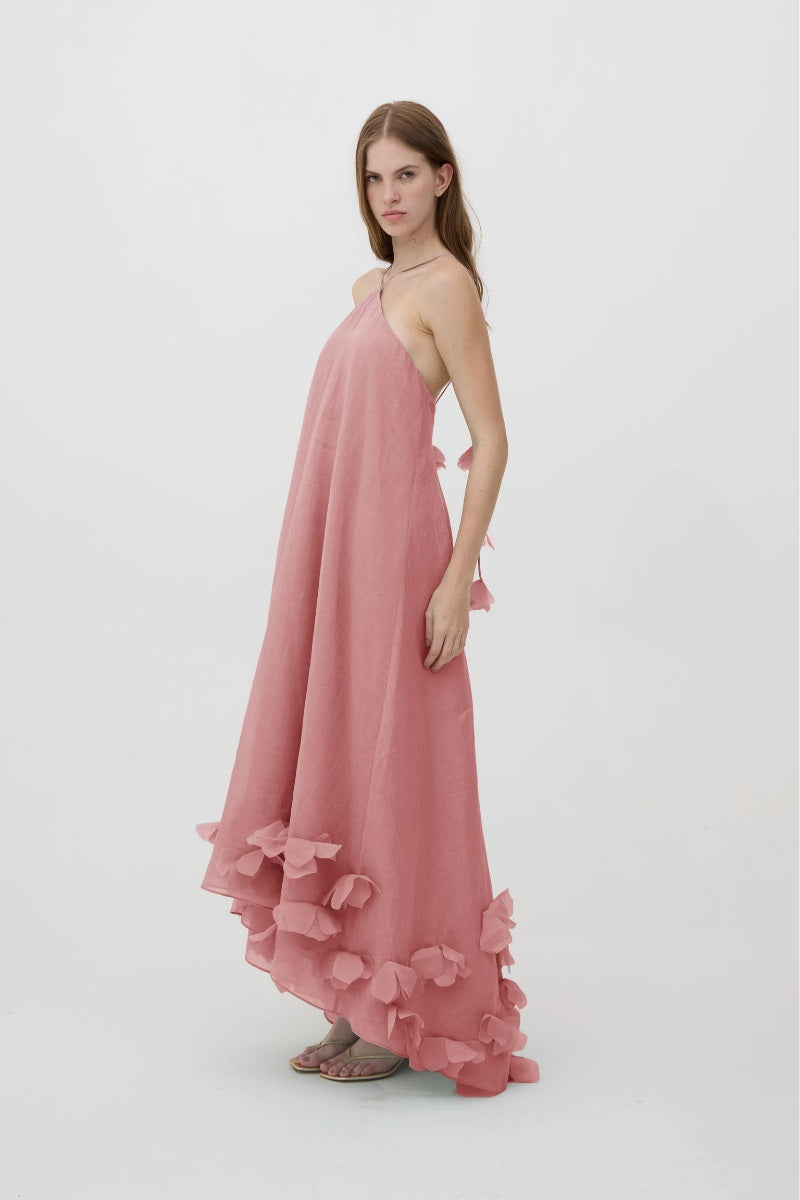 Pink Kontenta Aurora maxi dress with flowing fabric and elegant design, shown on a model.