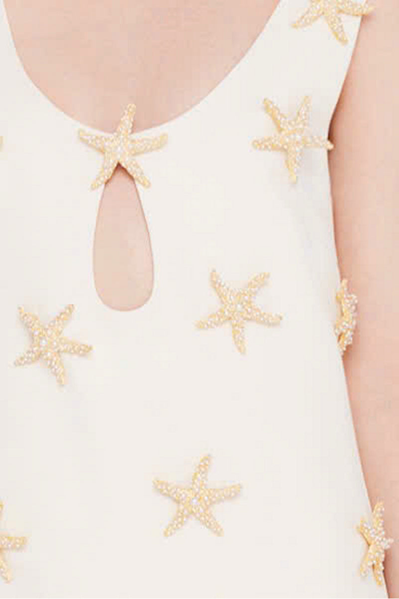 Valenciani starfish mini dress in ivory, lightweight fabric, sleeveless design, and fitted silhouette perfect for summer wear.
