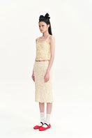 Beige Nora tank top by Chictopia, casual sleeveless top with a relaxed fit, displayed on a hanger against a neutral background.