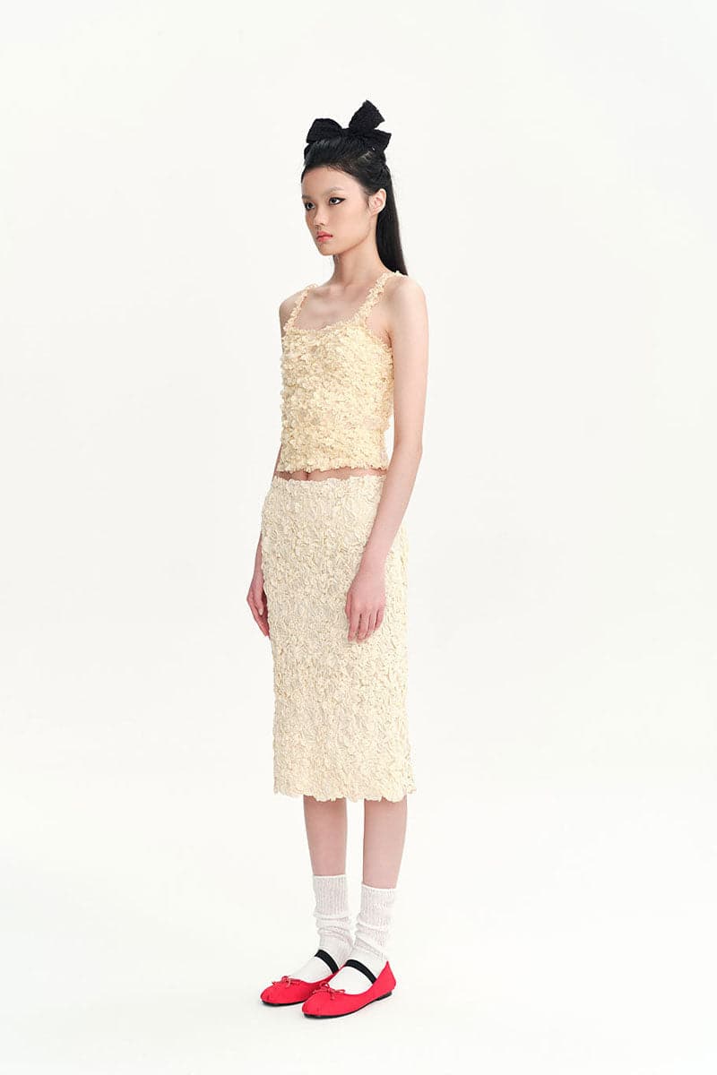 Beige Nora tank top by Chictopia, casual sleeveless top with a relaxed fit, displayed on a hanger against a neutral background.