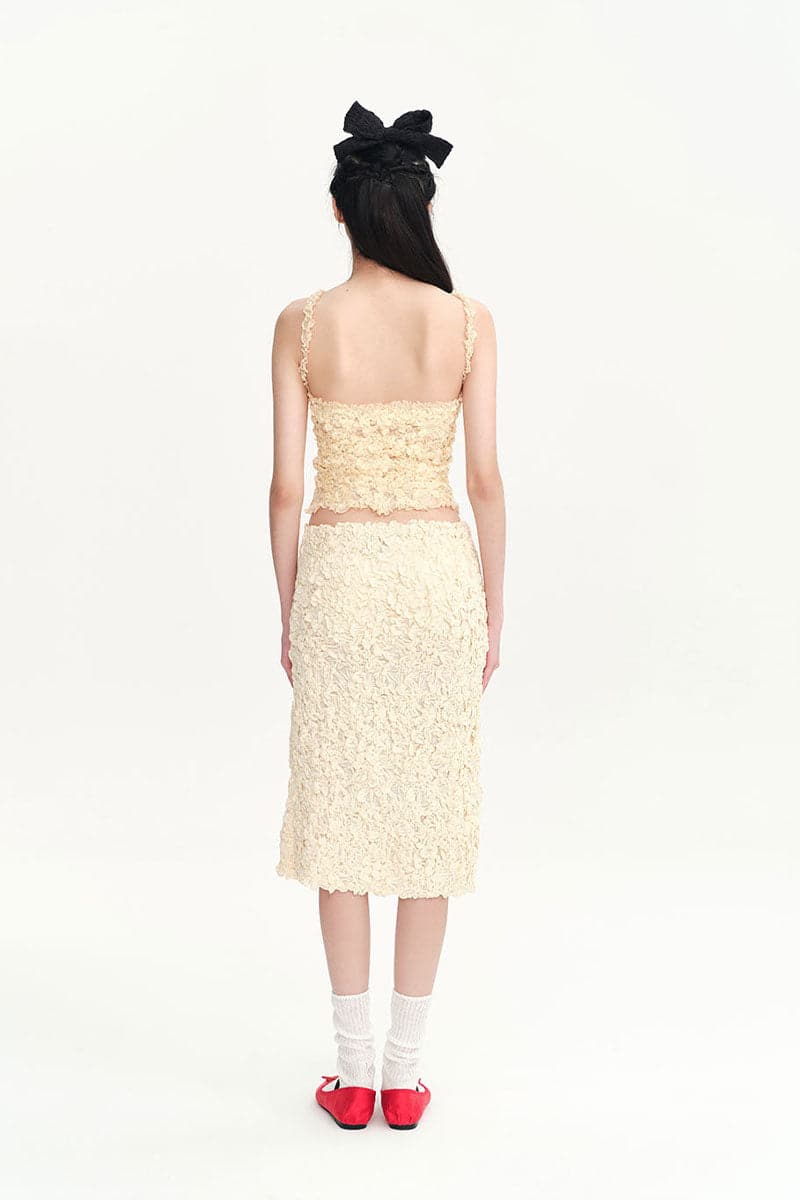 Beige Nora tank top from Chictopia, sleeveless top with a relaxed fit, fabric detail visible in the image.