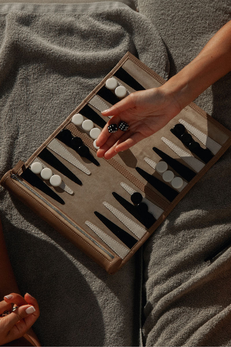 Travel Backgammon board in Manhattan design by Throwing Doubles, featuring a compact game set with colorful pieces on a stylish board.