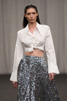 Lili Blanc tailored oversized cotton shirt displayed on a hanger, showcasing its relaxed fit and soft fabric.