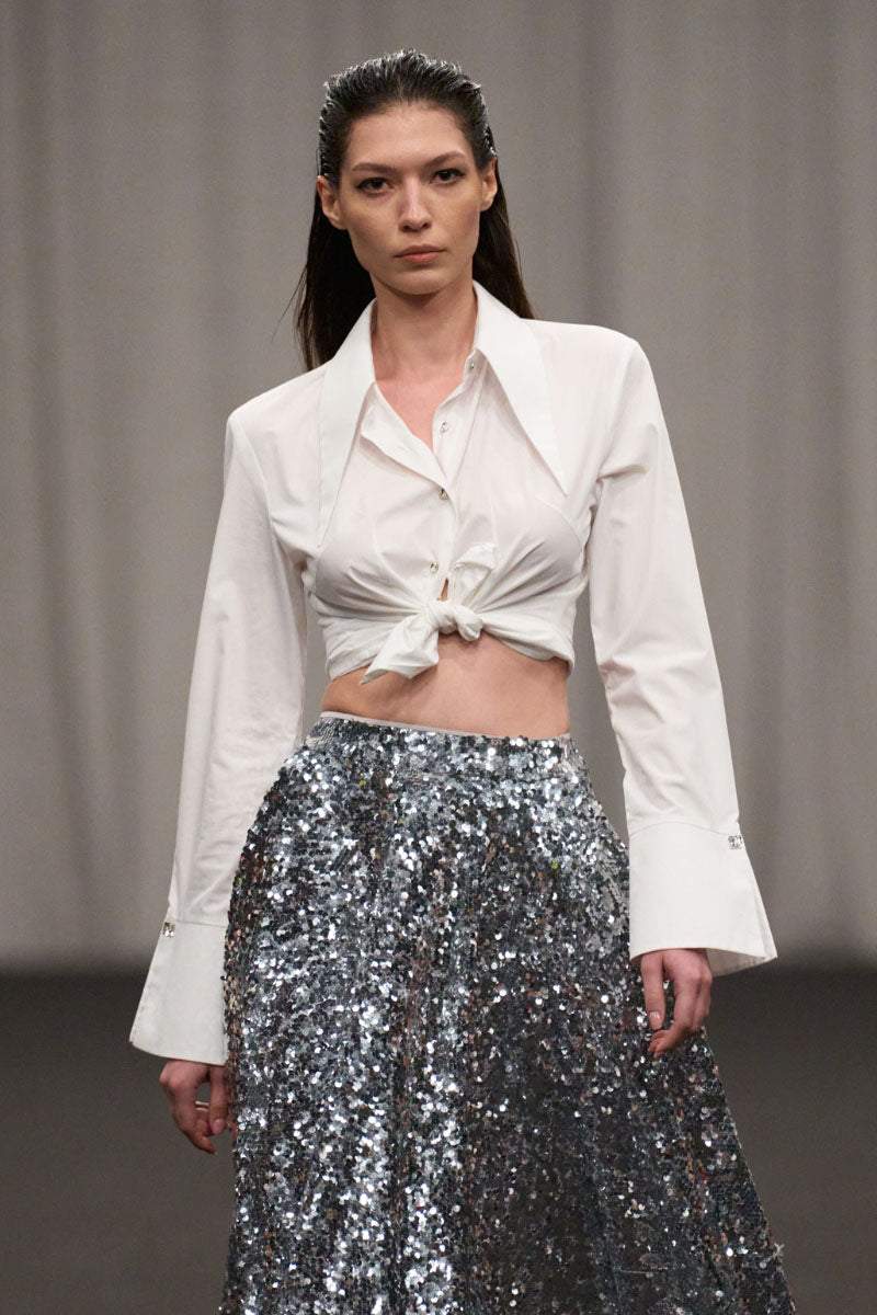 Lili Blanc tailored oversized cotton shirt displayed on a hanger, showcasing its relaxed fit and soft fabric.