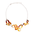 Salvárea interconnection necklace in amber with intricate design, showcasing warm amber beads and delicate craftsmanship.