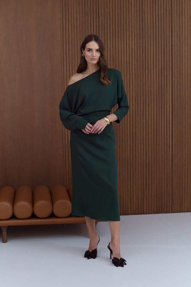 UNDRESS Agalia deep green off-the-shoulder midi dress displayed on a hanger, showcasing its elegant design and fabric details.