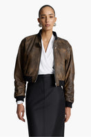 Acaria Studio Nostalgie leather bomber jacket with classic design, displayed on a hanger showing its sleek, stylish appearance.
