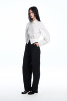 Chictopia Elodie wide leg pleated trousers, stylish beige pants with a high waist and flowing wide-leg design.
