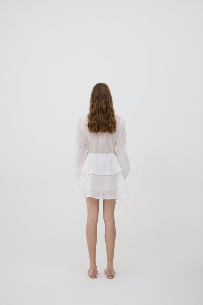 White Sofia mini dress by Kontenta, featuring a fitted silhouette and stylish design, perfect for casual or semi-formal wear.