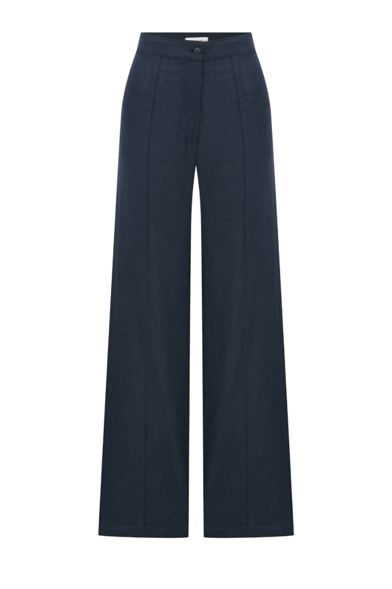 Nazlı Ceren Millie linen trousers in dark navy, showing a relaxed fit with a waistband and side pockets on a model.