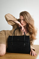 Black CELINE shoulder bag by VIKELE STUDIO, featuring a sleek design with leather strap and minimalistic style.