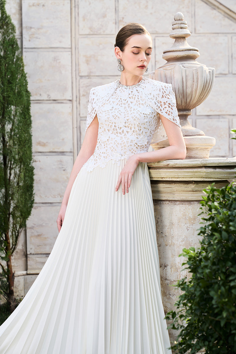 Tracy Studio grain weave gown displayed on a mannequin, showcasing its textured fabric and elegant design.