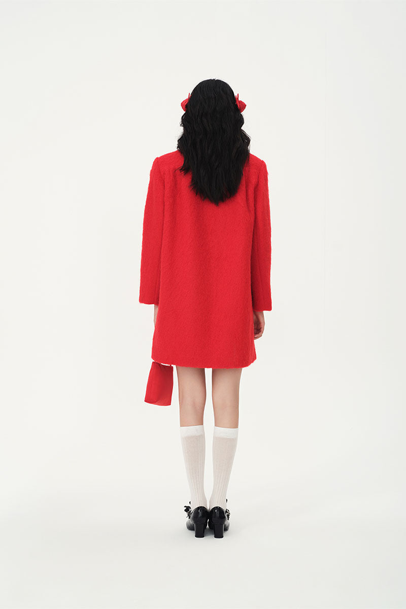 Chictopia ruby wool coat displayed on a hanger, featuring a classic tailored design with a front button closure and warm fabric.