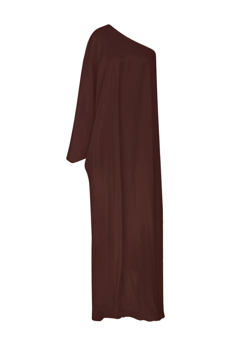 Nazlı Ceren Venus one-shoulder maxi dress in dark chocolate, flowing fabric with elegant drape and stylish shoulder design.