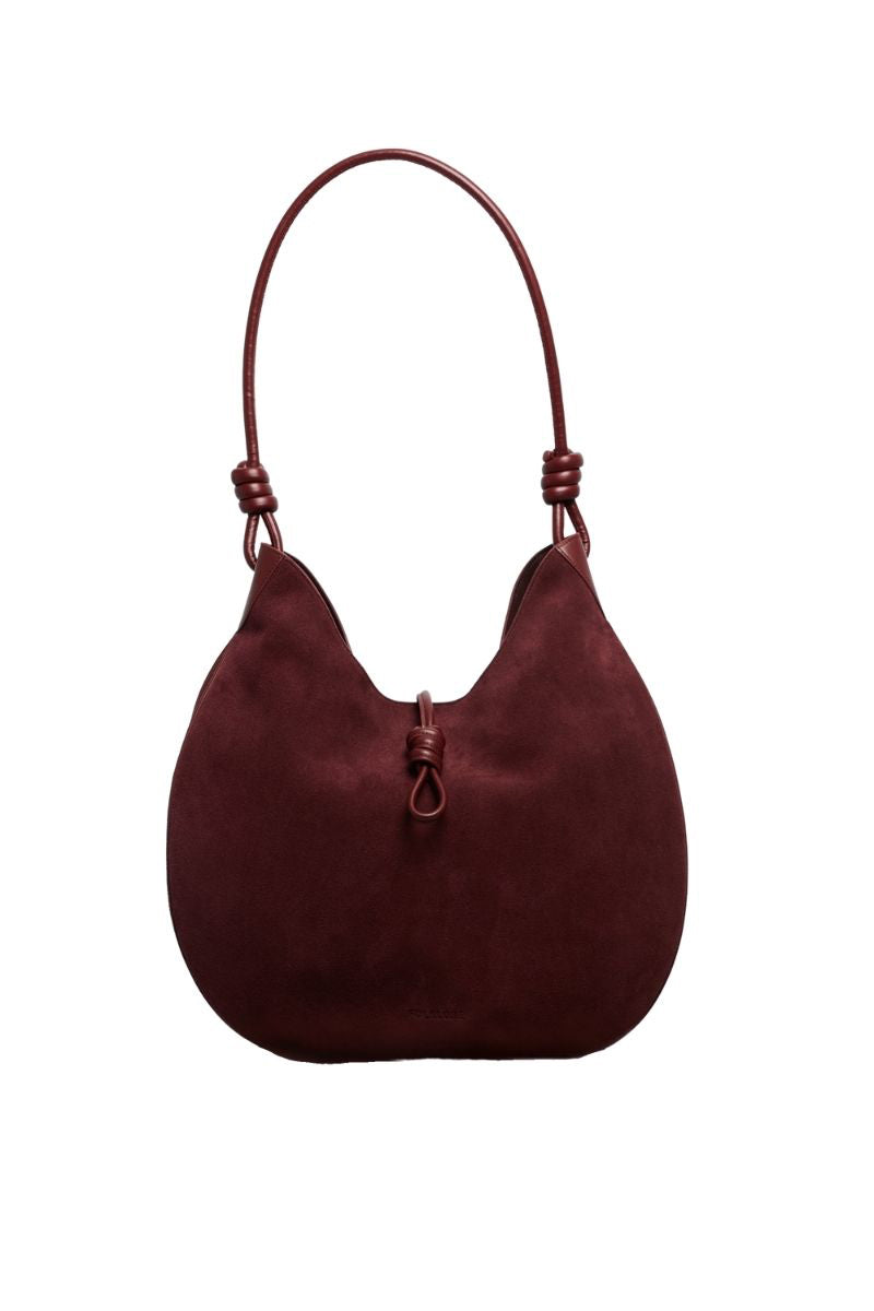 Maroon suede boho shoulder bag by Folklore The Label featuring a relaxed, stylish design and natural suede texture.