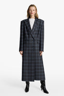 Acaria Studio Charlotte coat in neutral fabric, featuring a tailored fit and classic design, shown on a model.