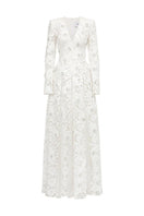 Elegant floral long sleeve lace gown by Tracy Studio, featuring intricate lace detail and a flowing silhouette.