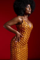 Onalaja ASHA midi dress in gold, featuring elegant fabric and a stylish midi length, displayed on a hanger against a neutral background.