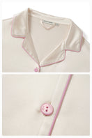 Soft blush pink silk pajama set by Not Just Pajama featuring long sleeves and relaxed fit for comfortable sleepwear.