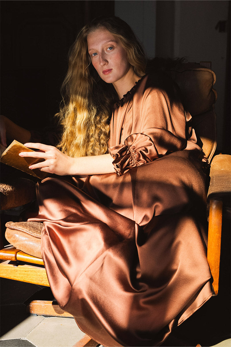 Brown silk custom gown robe by Not Just Pajama, showcasing smooth fabric and elegant design on a model.