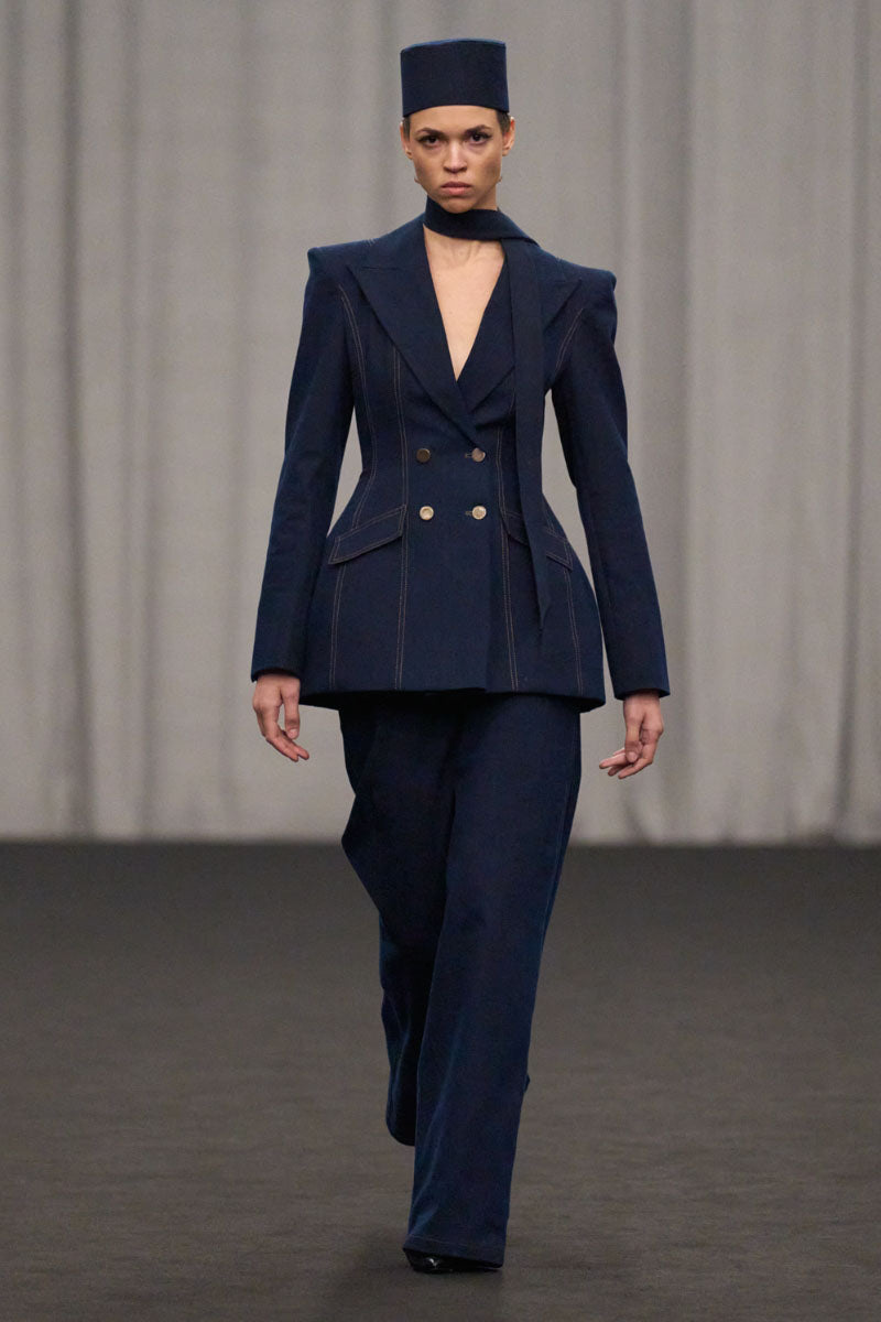 Lili Blanc double-breasted tailored denim blazer with notch lapel, front pockets, and structured fit, shown on a model.