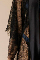 Entos black Kiharu long satin pajamas robe draped on a hanger, showcasing smooth satin fabric and elegant long design.