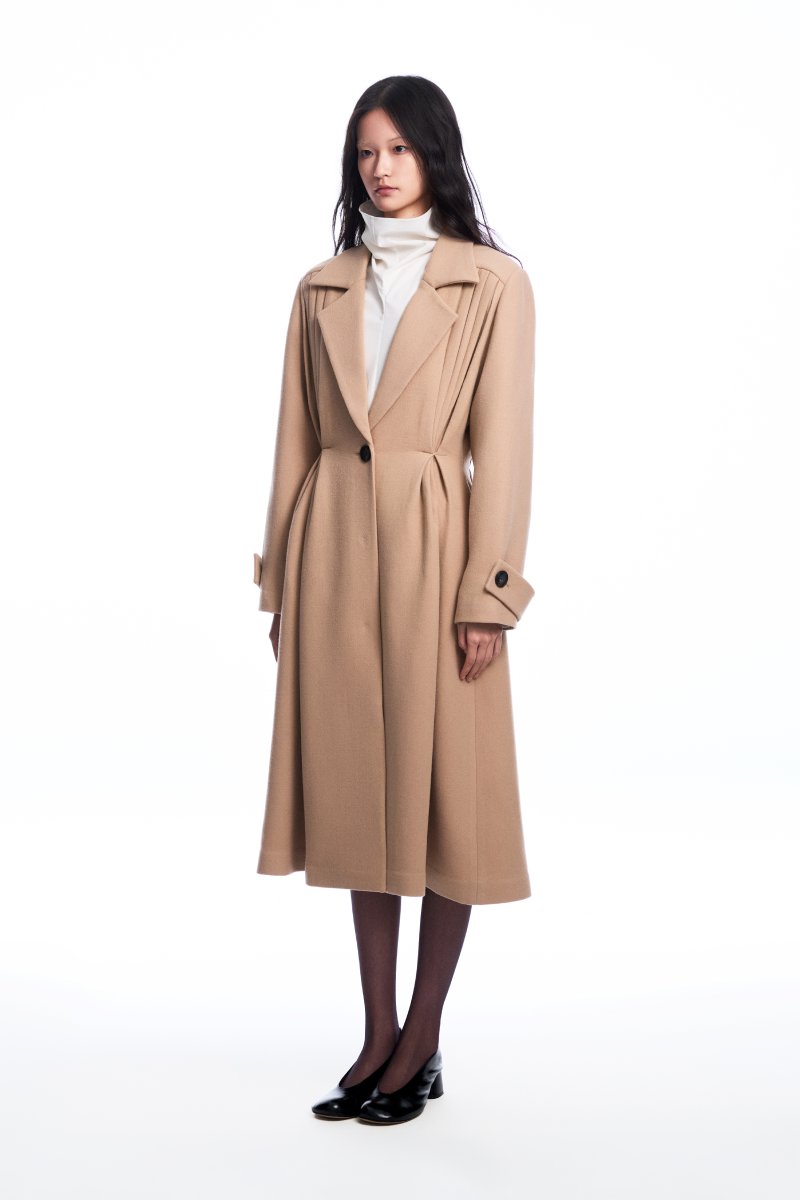 Beige pleated wool coat by Chictopia, featuring a tailored fit and classic design, displayed on a hanger against a neutral background.