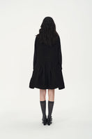 Chictopia DORA wool coat in beige, stylish long coat with button closure, worn by a model outdoors.