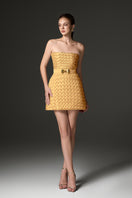 Yellow smocked silk bustier mini dress by I.H.F Studio, featuring fitted bodice and stylish mini length, displayed on a mannequin.