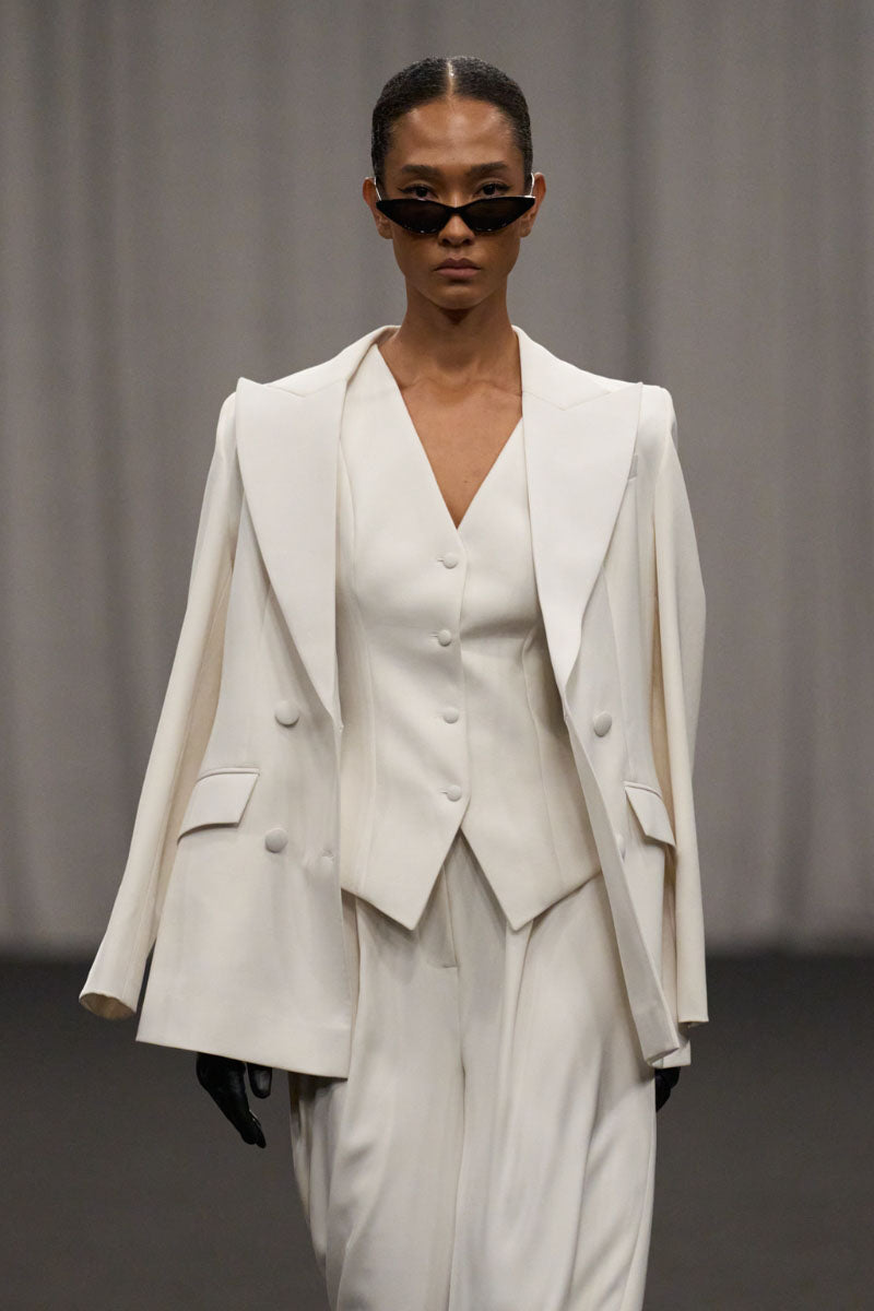 Lili Blanc chic sculpted sleeveless vest with a fitted design, displayed on a neutral background.