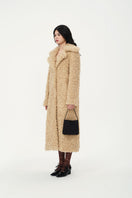 Chictopia Leona faux fur coat in cream with plush texture, stylish and warm outerwear for winter or cold weather.