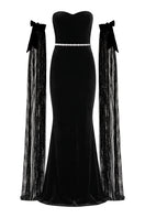 Nur Karaata Daisy Gown displayed on a mannequin, featuring a flowing design with floral accents and elegant fabric details.