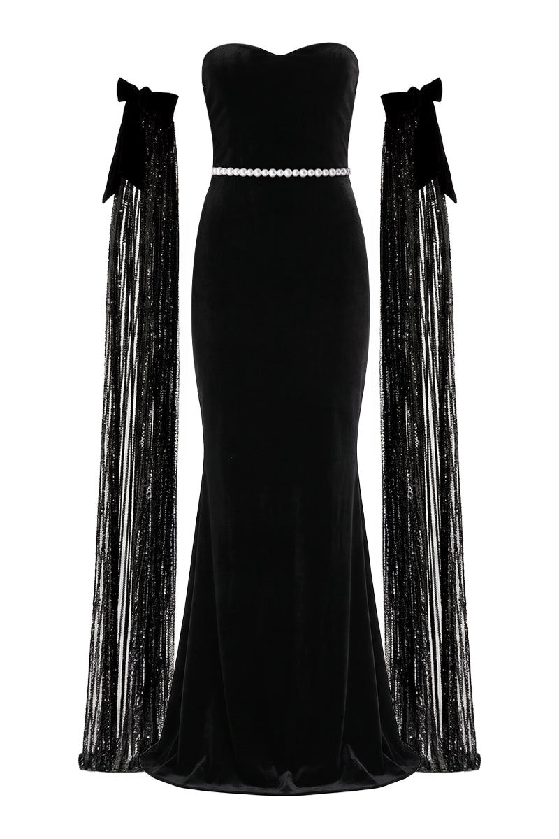 Nur Karaata Daisy Gown displayed on a mannequin, featuring a flowing design with floral accents and elegant fabric details.